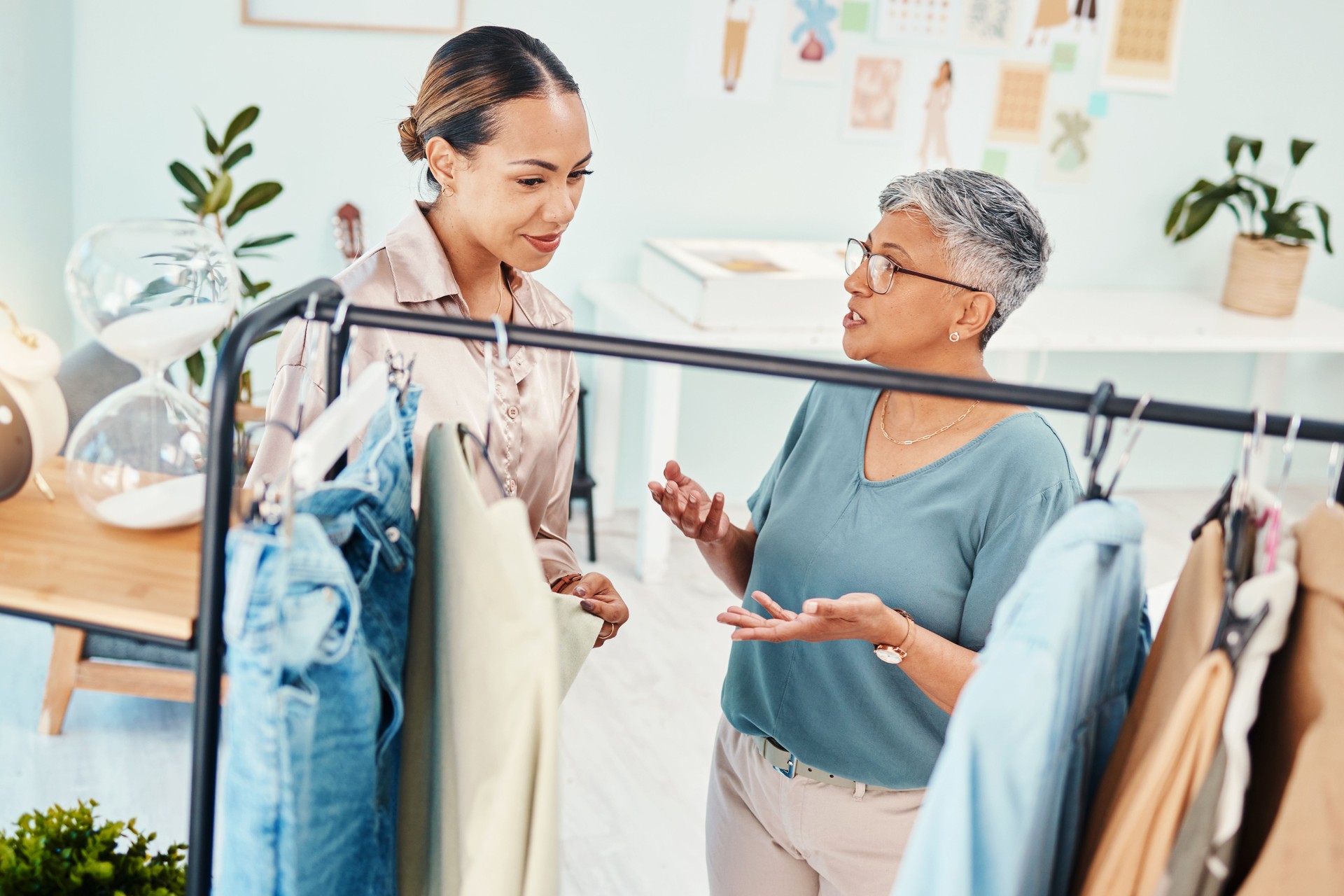 Consultant, fashion and shopping with client in shop for advice on fabric or products on promotion. Customer, retail sale or women talking in boutique mall for clothes deal, help or discount offer
